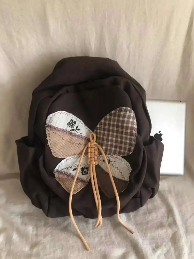 2025 ใหม่ Patchwork ผีเสื้อกระเป๋านักเรียนกระเป๋าเป้สะพายหลังไหล่กระเป๋านักเรียนวัยรุ่นของขวัญ B1979 hit