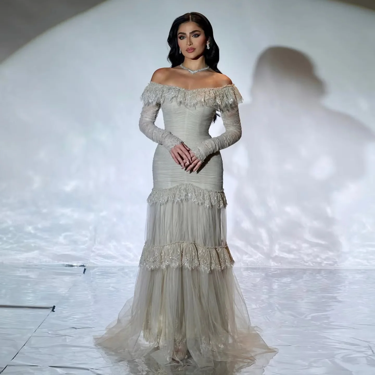 This off-shoulder mermaid evening gown features long sleeves and delicate ruffle trim. Custom sizes available. Perfect for prom,