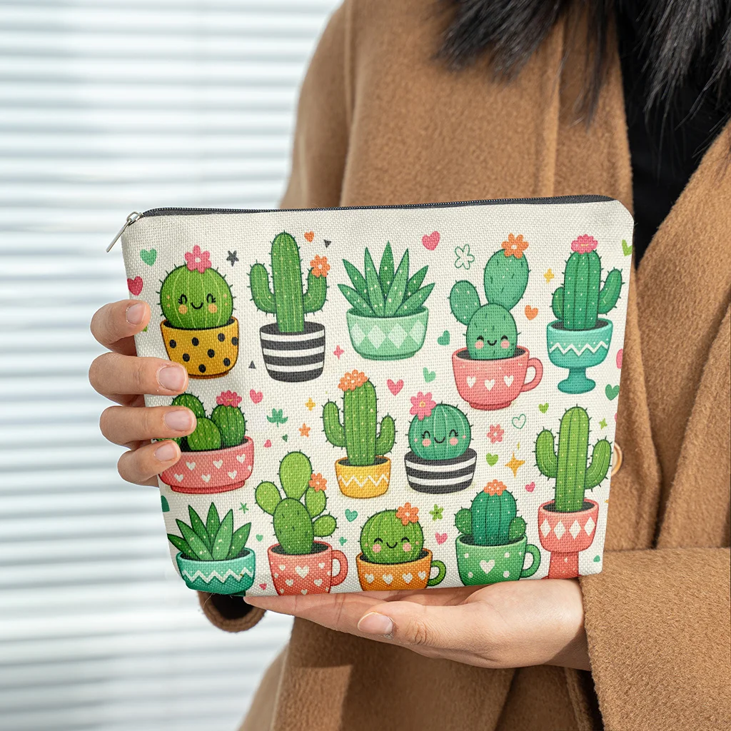 A Makeup Bag Featuring Various Cartoon-Style Cactus Illustrations Made Of Linen. It'S A Lightweight Zippered Cosmetic Pouch Th