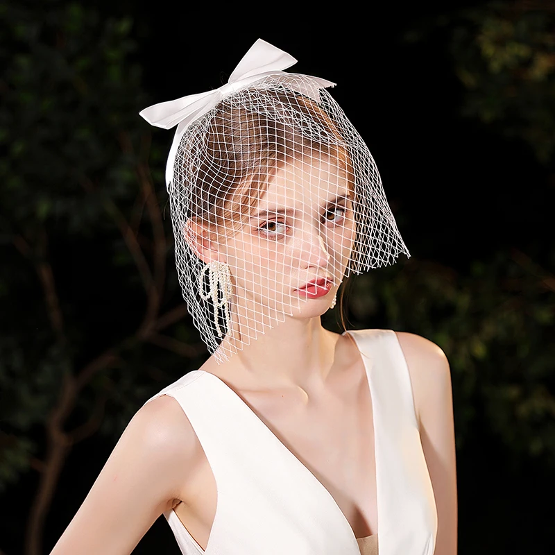 A white elegant bride's veil adorned with a simple bow, suitable for women's wedding fishing nets and birdcage veils