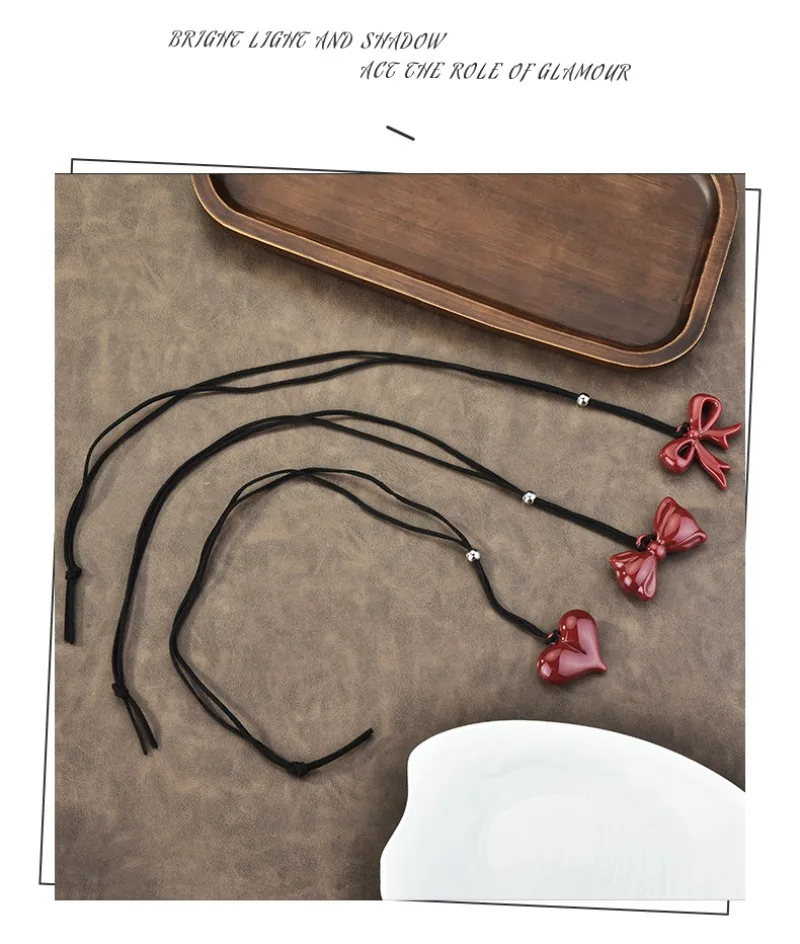

2025 Wine red ribbon bow pendant necklace, a long red sweater chain for women's peace of mind