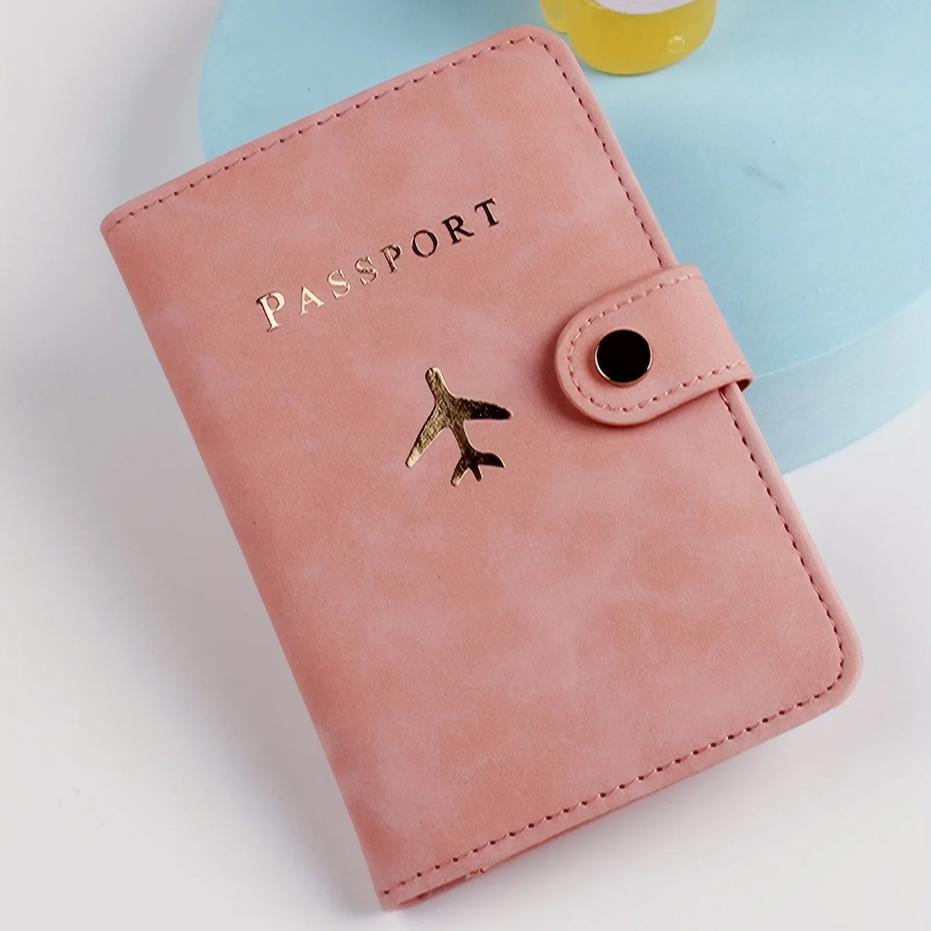 

Compact Travel Passport Wallet with Airplane Embossment - Secure Snap & Card Pockets, Stylish Jet-Setter Accessory