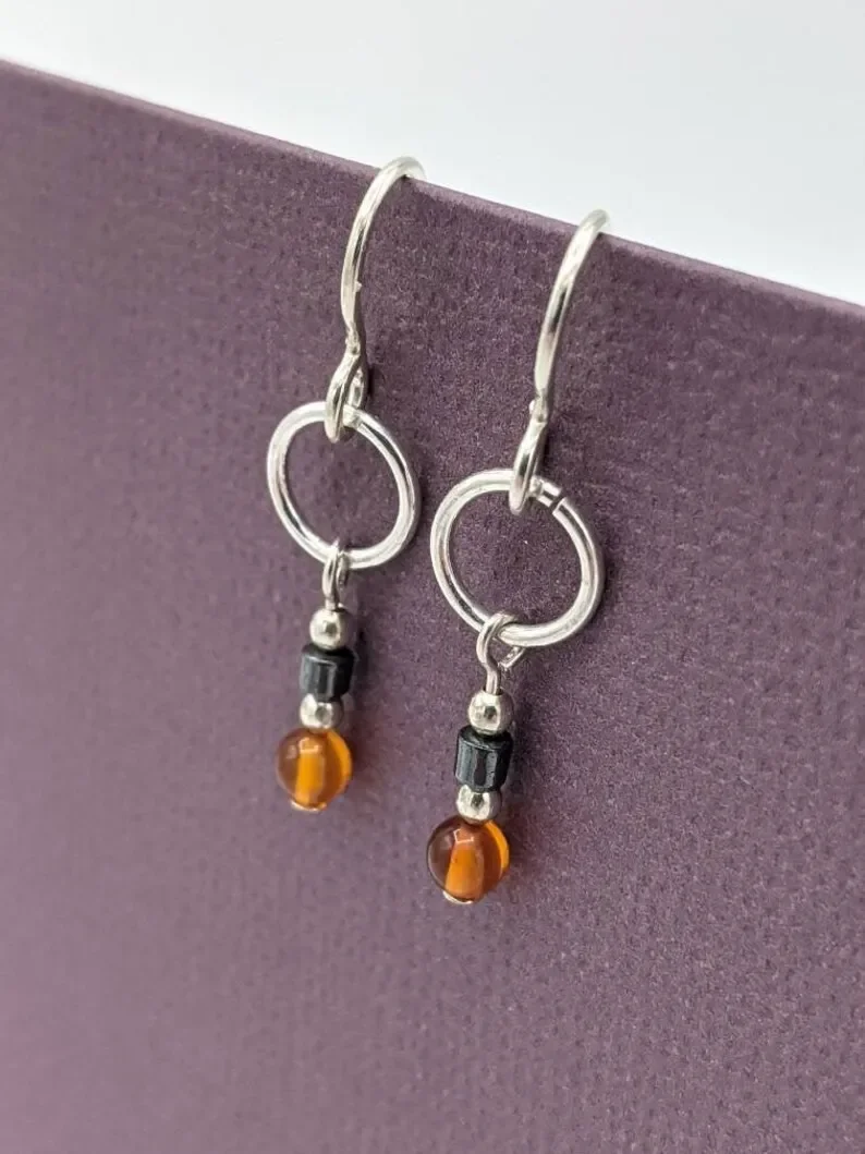 Amber earrings, small ring pendant earrings, real amber and hematite earrings