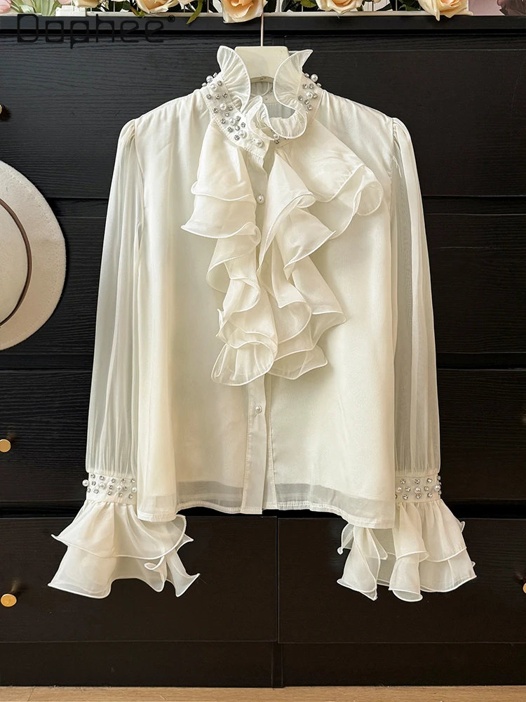 Camisa de manga acampanada con cuello levantado y perlas de gama alta de estilo francés para mujer otoño 2025 Top elegante de moda con una sola botonadura