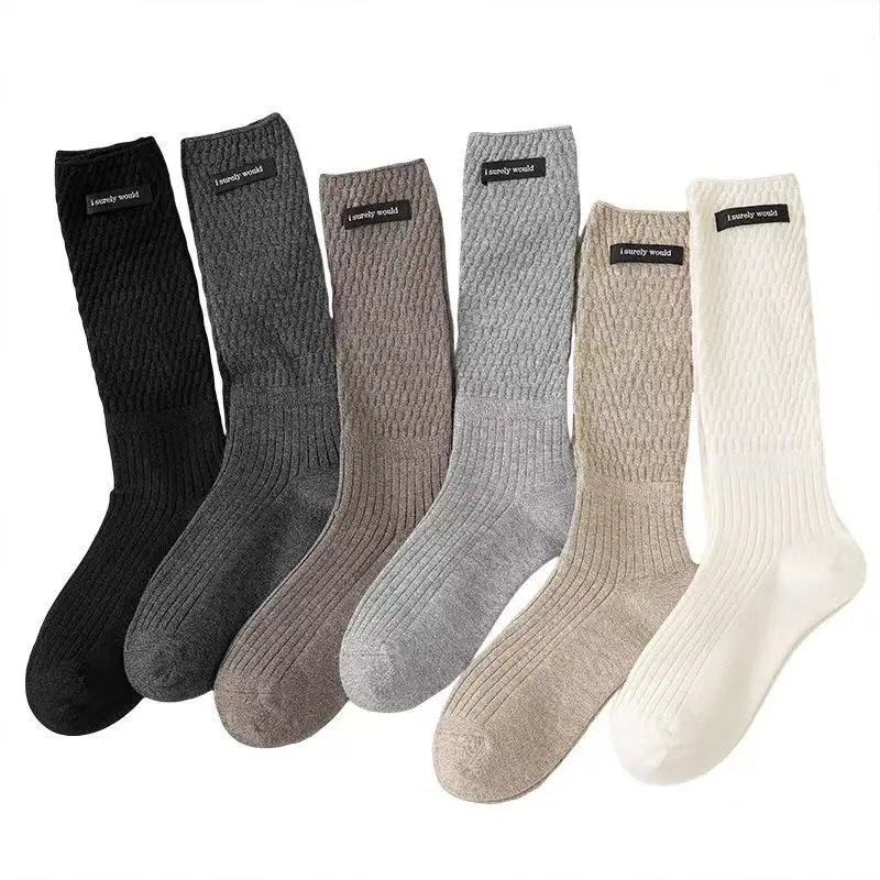 Winter and autumn warm pure color women's calf socks, pile socks, gray fabric label, studded pattern. Christmas and New Year.