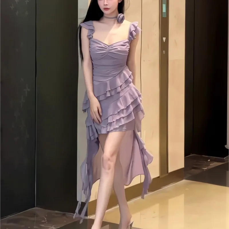 An irregularly ruffled sleeveless halter dress with a purple cinched waist and drawstring
