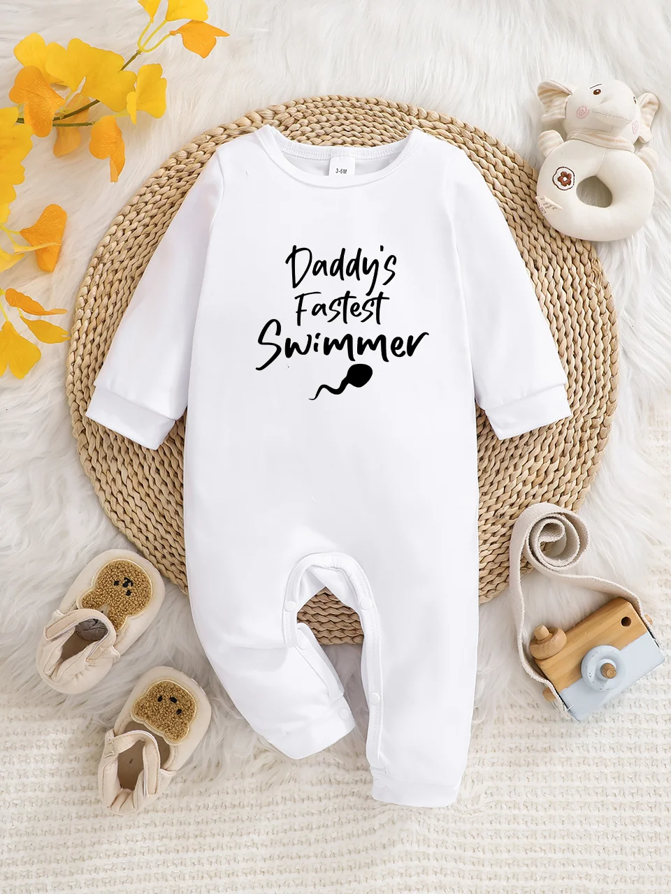 A baby long-sleeved onesie with interesting letter prints. It features a buttoned design for easy putting on and taking off