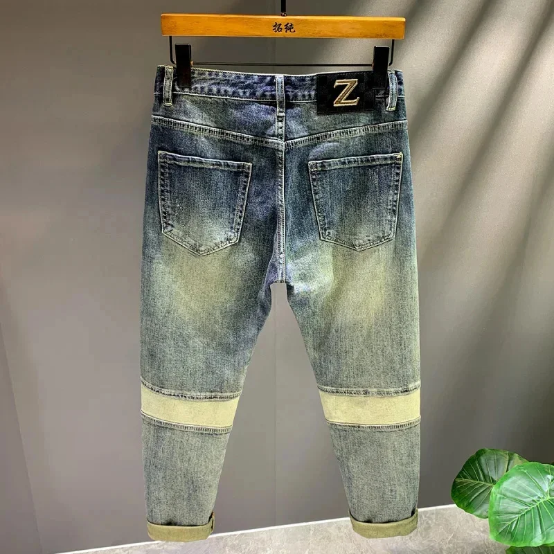 Primavera e outono 2026 nova marca na moda emenda remendo retro jeans calças masculinas fino ajuste pés pequenos rascal bonito denim
