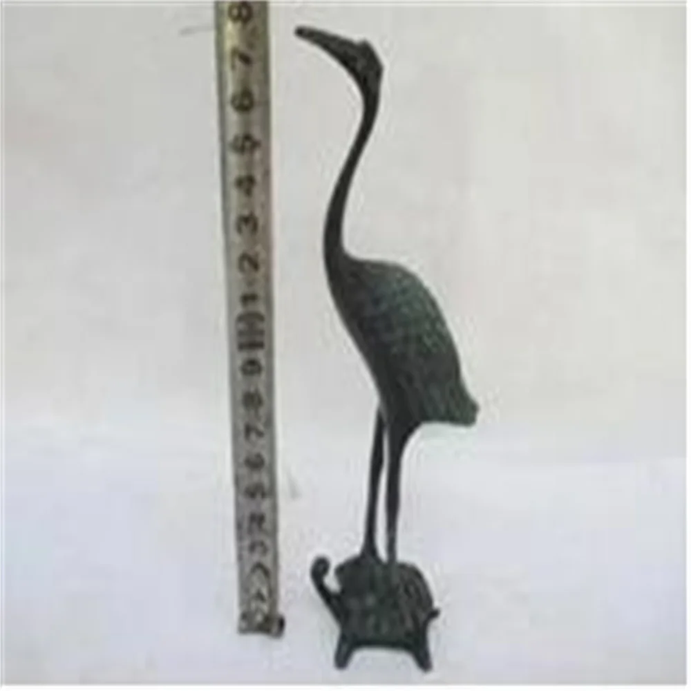 An ancient Chinese bronze collection crane standing on a turtle statue