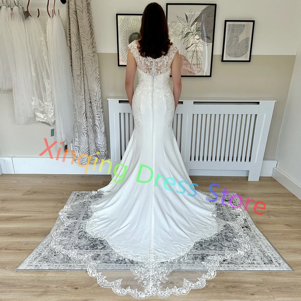 Abiti da sposa personalizzati con applicazioni in jersey scoop maniche ad aletta abiti da sposa a sirena con strascico in pizzo con bottoni sul retro realizzati su misura