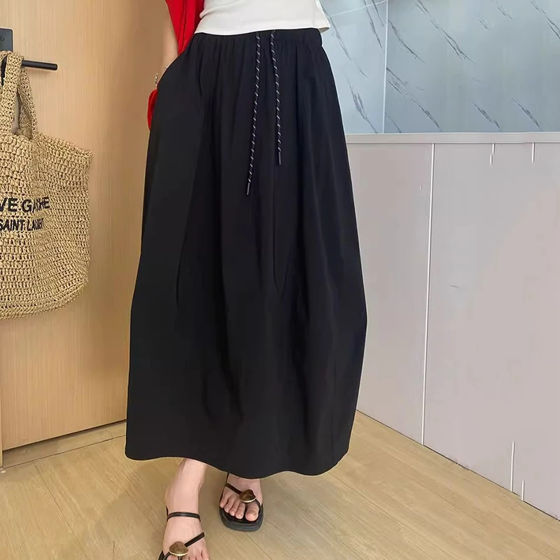 تنورة نسائية صيفية من الحرير الجليدي لعام 2025 بخصر مطاطي كوري تنانير طويلة على شكل حرف A للسيدات بأربطة ملابس خروج رفيعة تنانير نسائية