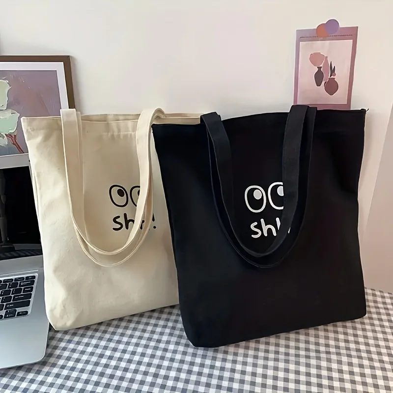 A Casual and Versatile Canvas Bag with Cartoon Eye Pattern, Large Capacity Tote Bag Suitable for Both Men and Women, 