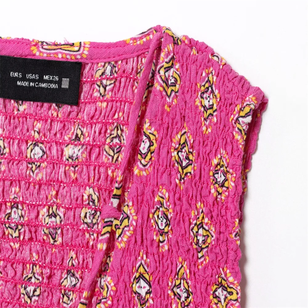 بلوزة نسائية صيفية جديدة لقضاء العطلات على شكل قرص العسل مطبوعة برقبة على شكل حرف V بدون أكمام وتنورة ميدي عالية الخصر