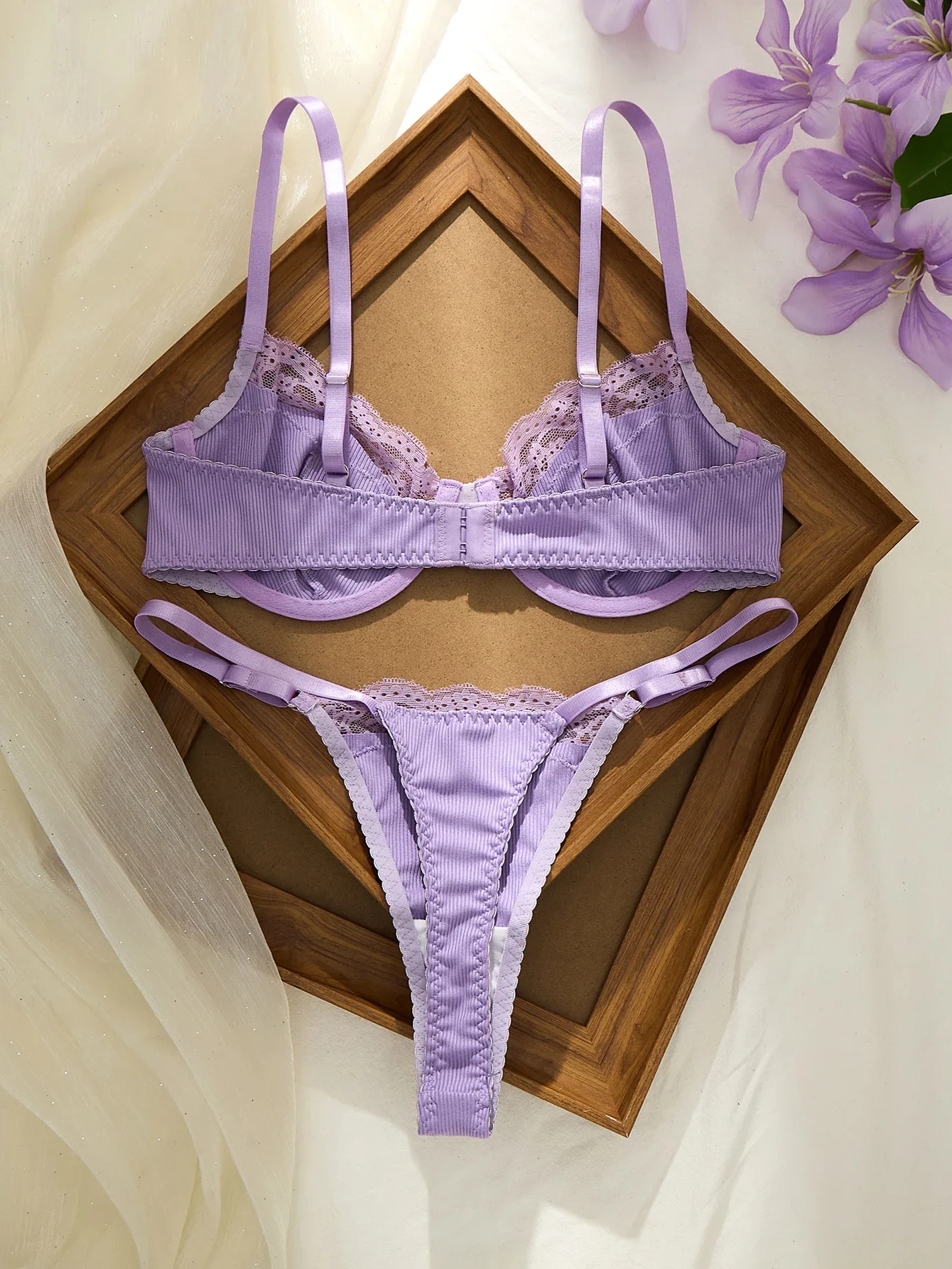 Two-piece lingerie shown from another angle with soft lace trim and solid color design
