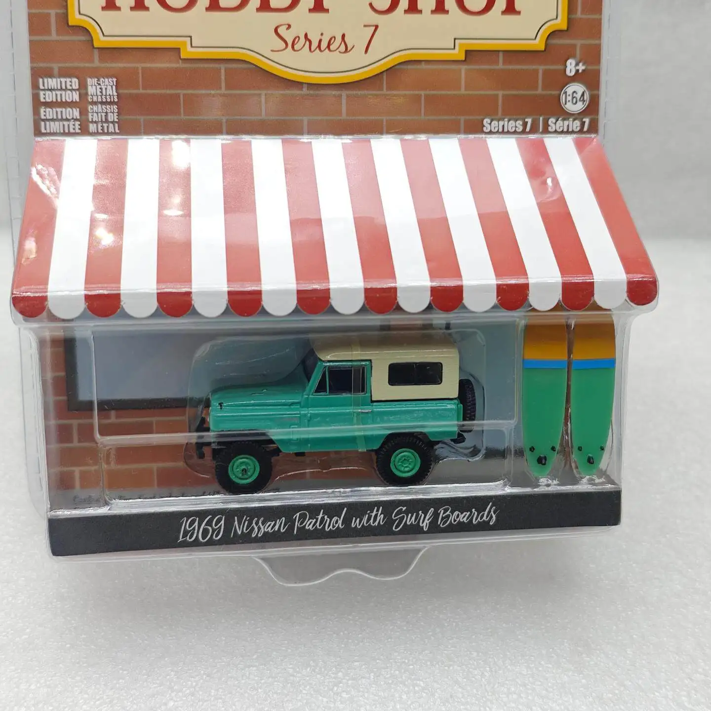 GreenLight 1:64 Hobby Shop Series 7 - 1969 Nissan Patrol (60) with Surfboard Diecast Alloy Car Model Collectible Gift