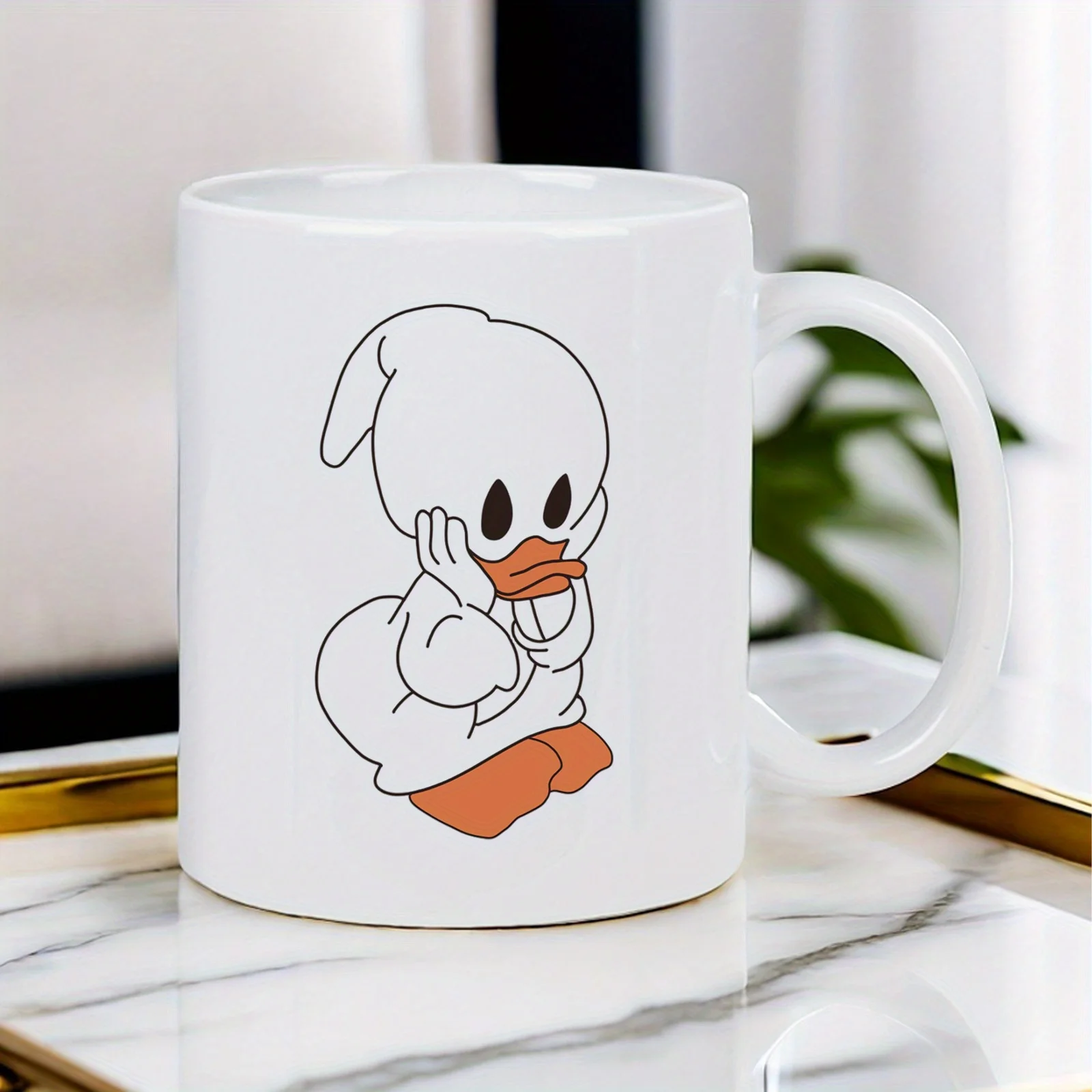 This white ceramic mug features a cute duck design, is reusable, and is suitable for home, office, or as a gift.