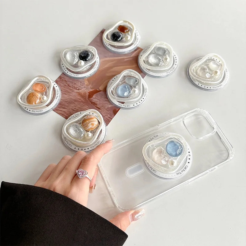 

Fresh ins mobile phone airbag holder magnetic suction retractable stone pearl light luxury desktop lazy Bed Phone Mounts