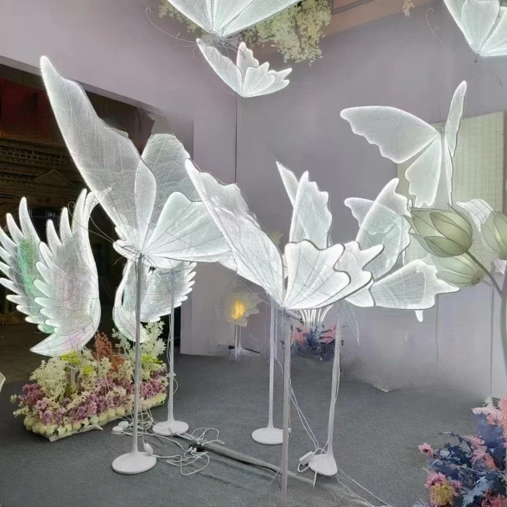 Wedding props are arranged with luminous butterfly wings, stage decorations, ceiling pendants, wedding road guide scenes and dec