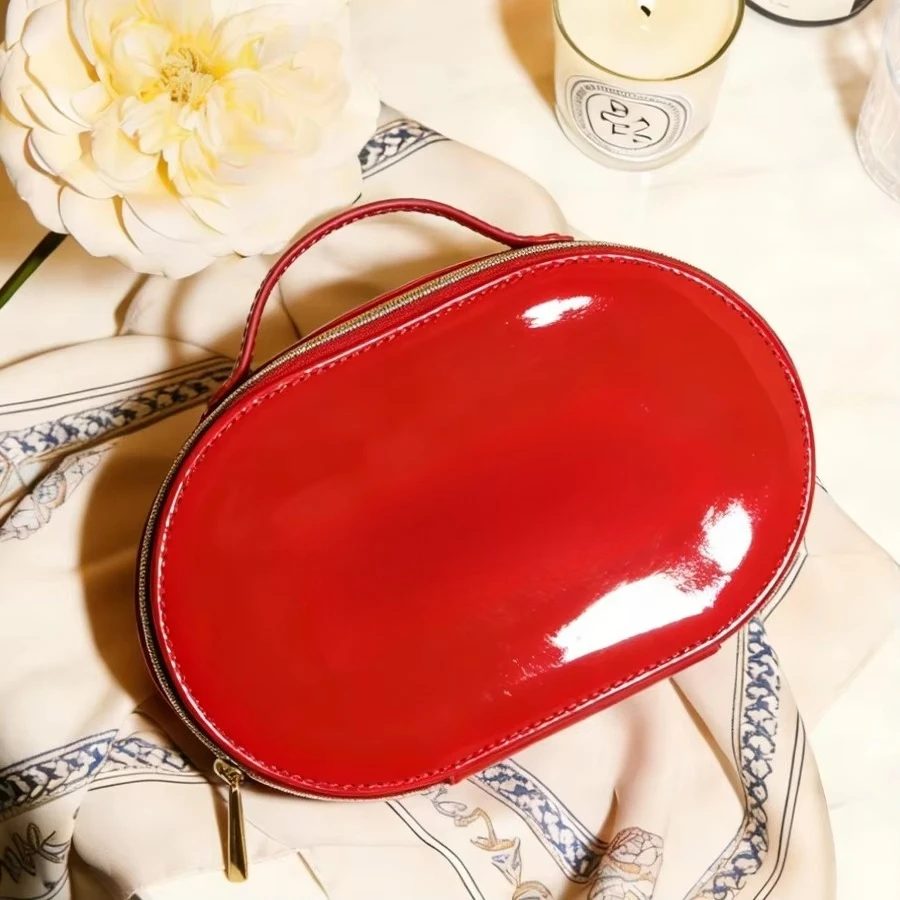 Luxury Glossy Bright Red Oval Handheld Makeup Storage Bag Patent Leather Embossed Logo Waterproof Travel Cosmetic Bag