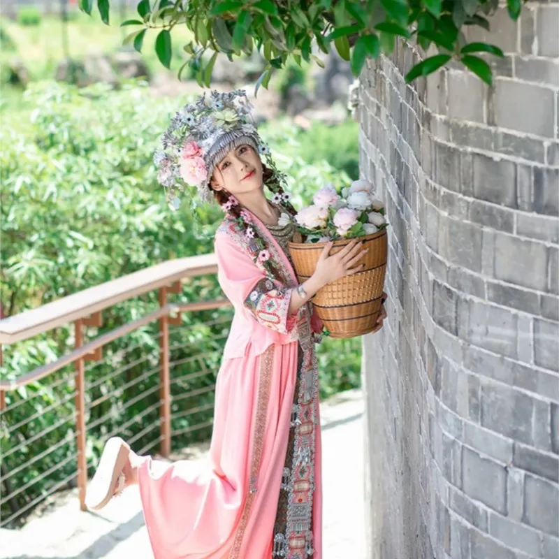 สาวสีชมพูชาติพันธุ์เครื่องแต่งกายที่แปลกใหม่เต้นรําการถ่ายภาพท่องเที่ยว