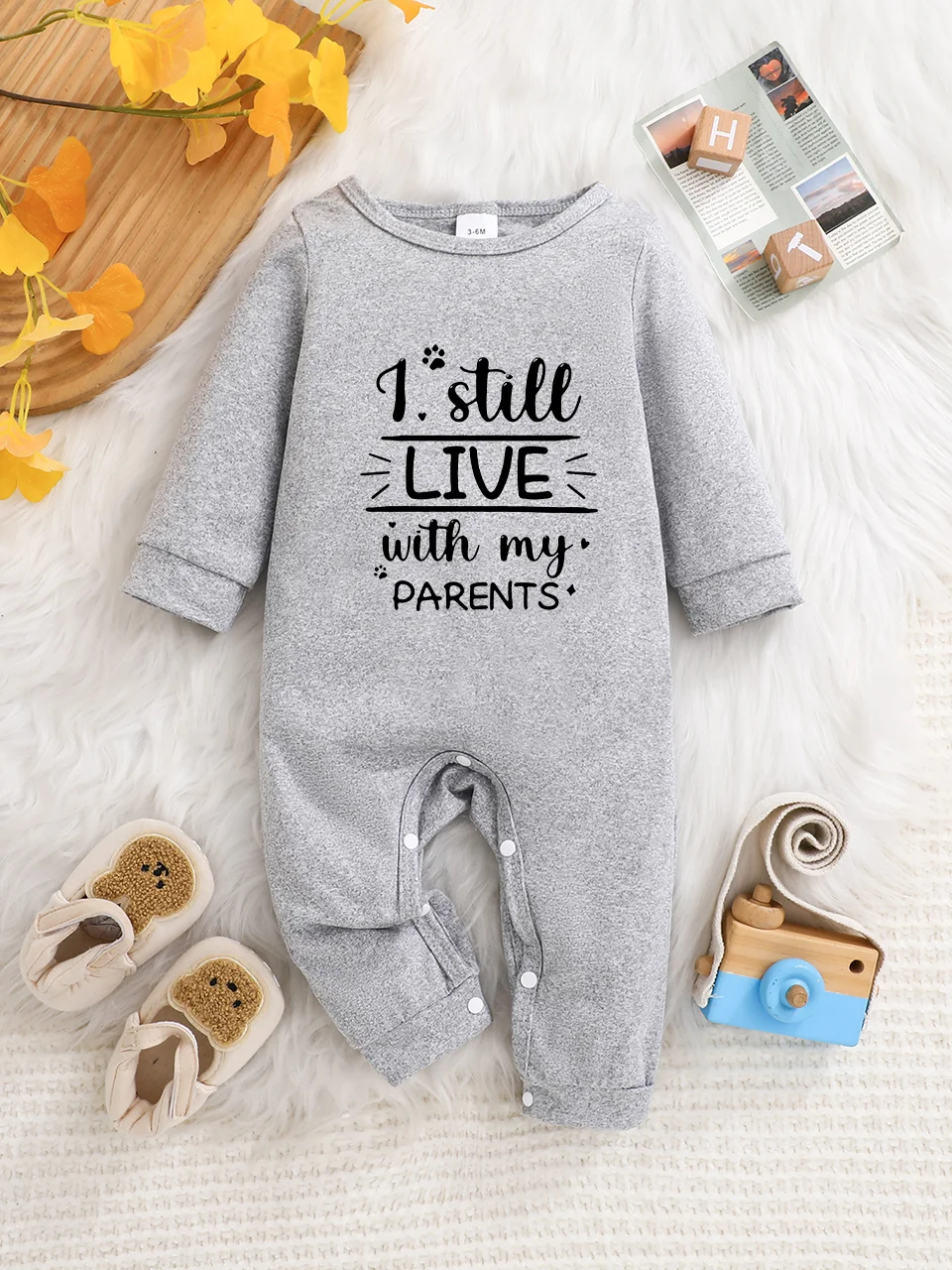A baby long-sleeved onesie with interesting letter prints. It features a buttoned design for easy putting on and taking off