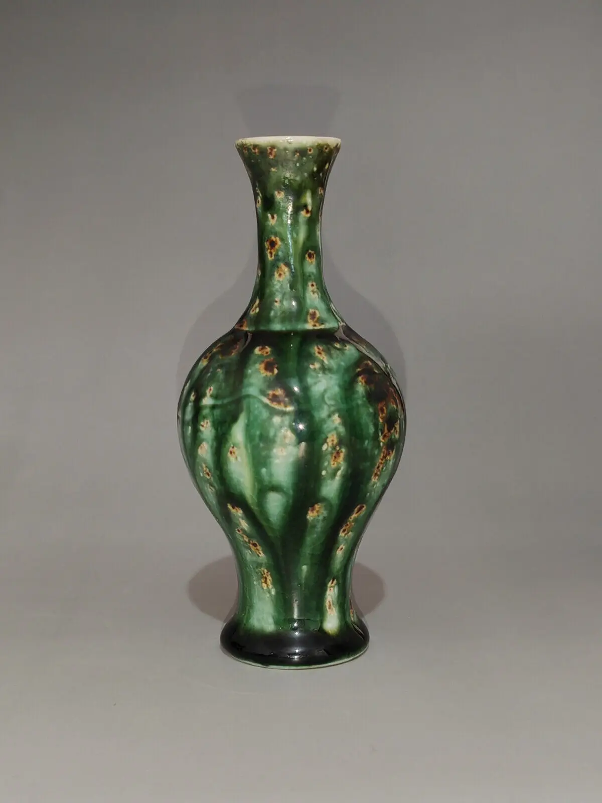 

A natural style Chinese small pear shaped ceramic product with green brown kiln