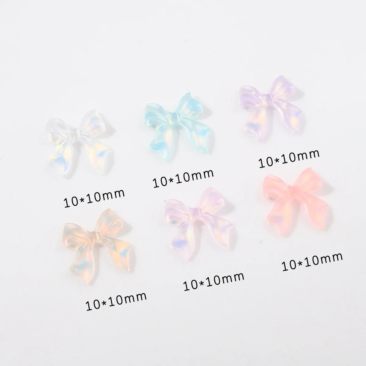 ชาร์มตกแต่งเล็บริบบิ้นออโรร่ามอคค่า 50 ชิ้น คละสี อุปกรณ์ตกแต่งเล็บ 3 มิติ เรซิ่น ประดับเล็บ อุปกรณ์ทำเล็บ