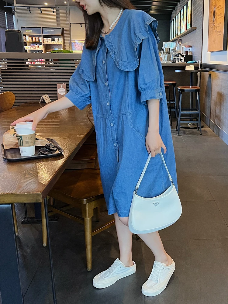 Letnia damska sukienka jednoczęściowa, luźny krój, kołnierzyk typu lalka, szerokie nogawki, modny detal falbanki, wysoki stan, detale z guzikami.