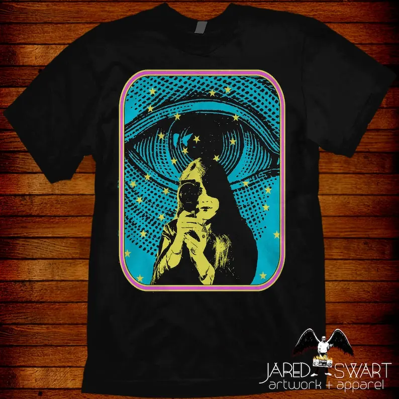 

Jared Swart Art Show 2021 tee: "Director's Eye" Sizes S M L XL 2XL 3XL 4XL 5XL also in ladies fit S-2XL