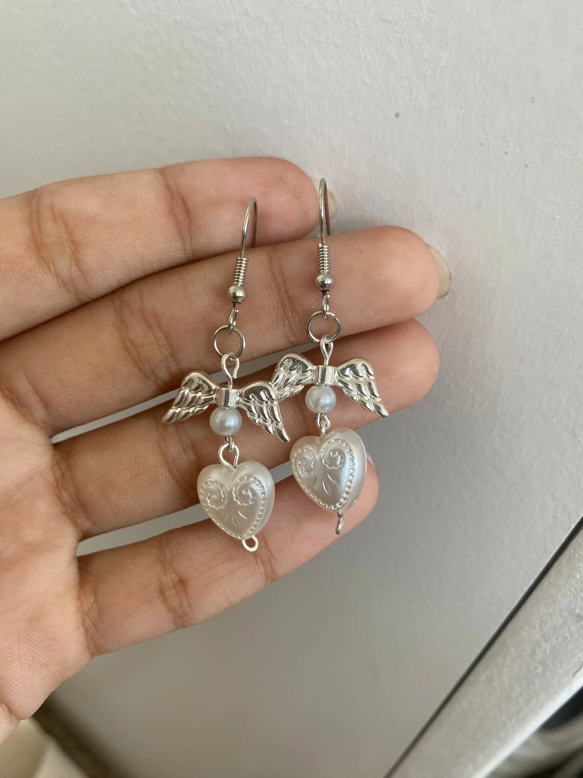 white coquette pearl angel earrings