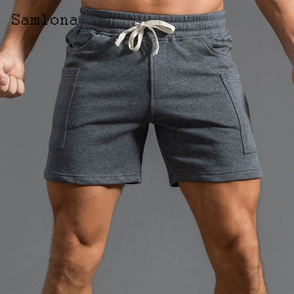 2025 ฤดูร้อนใหม่กางเกงขาสั้นสบายๆผู้ชายเซ็กซี่เอวยางยืดกางเกงขาสั้นชายขาตั้งกระเป๋าฟิตเนสชายหาดสั้นกางเกงสีเทาสีขาว