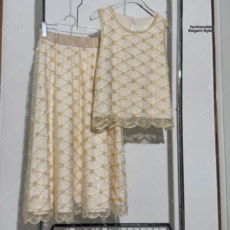 

Модный комплект: топ с круглым вырезом и обильной вышивкой пайетками, свободная юбка. Летний трендовый набор 2025 года.