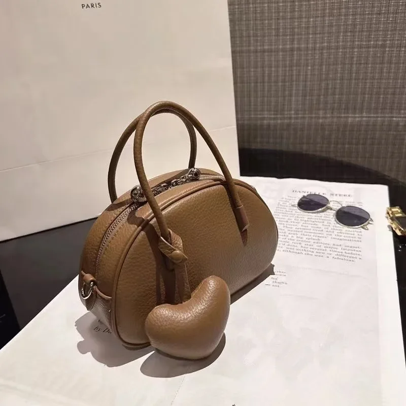 2024 women's handbag luxury designer heart-shaped crossbody bag solid color simple women, single bag