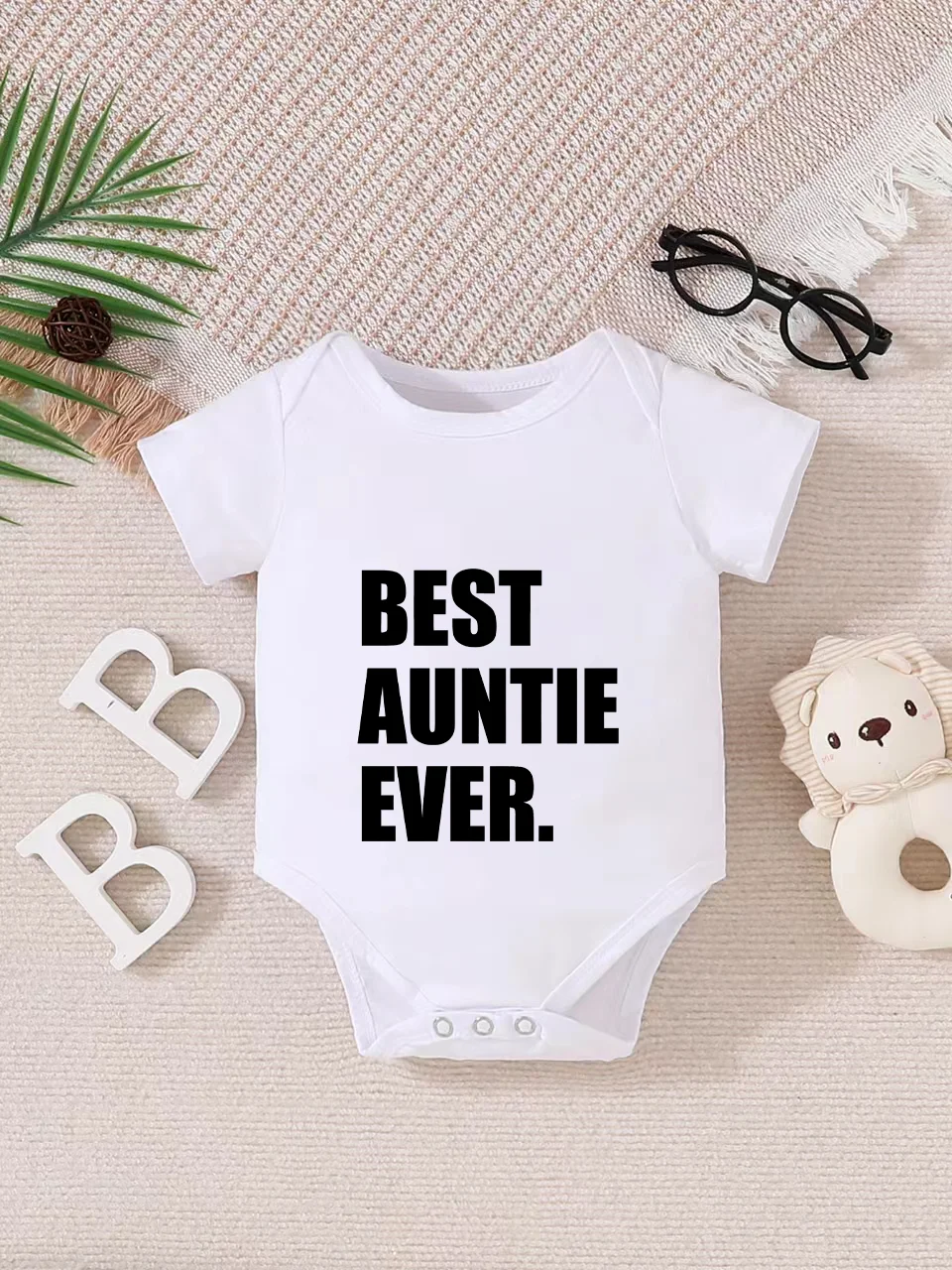 Playful letter-printed baby short-sleeve triangle bodysuit. Button closure for easy dressing, machine washable