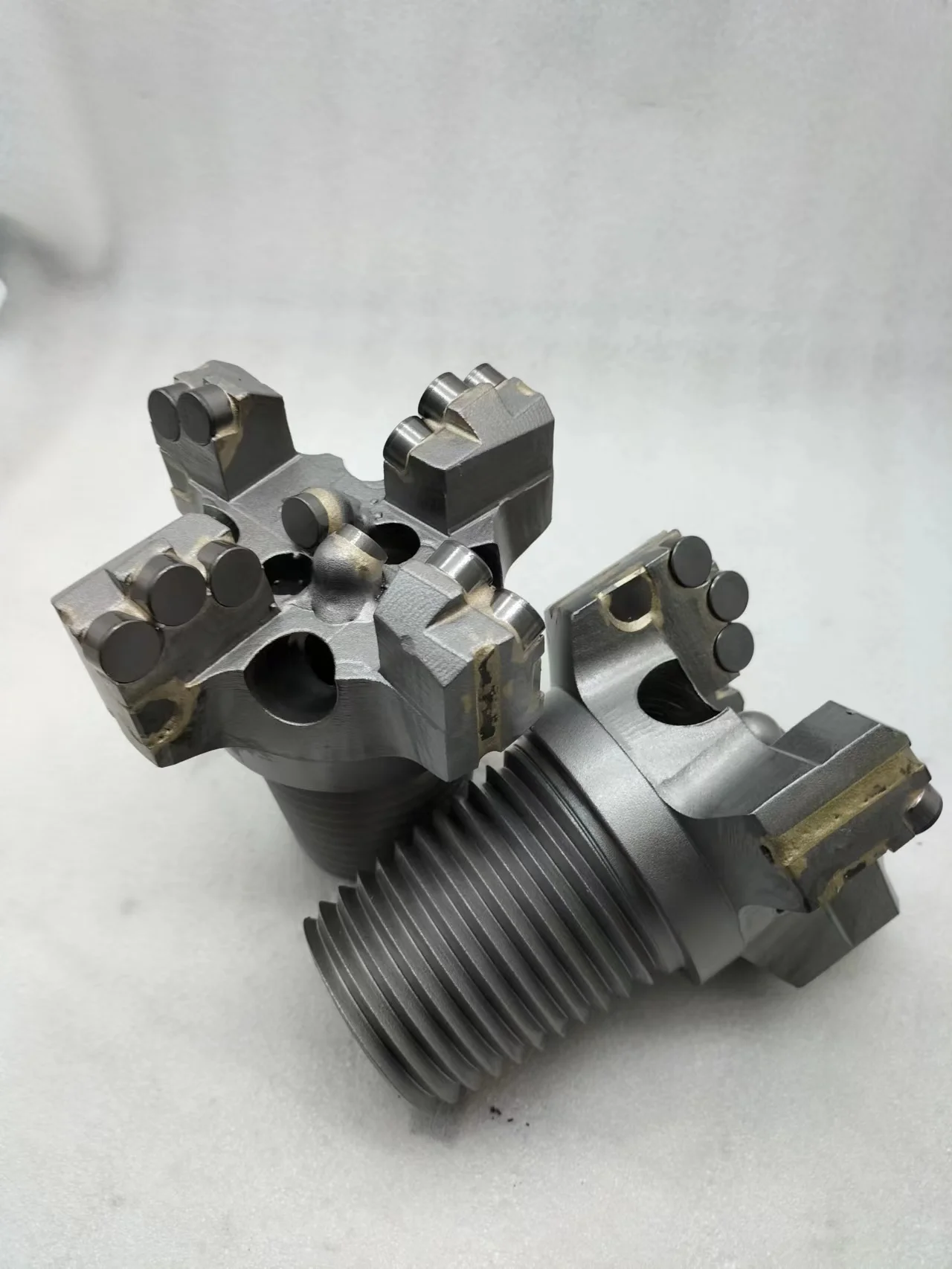 Customized four-wing concave coreless drill bit