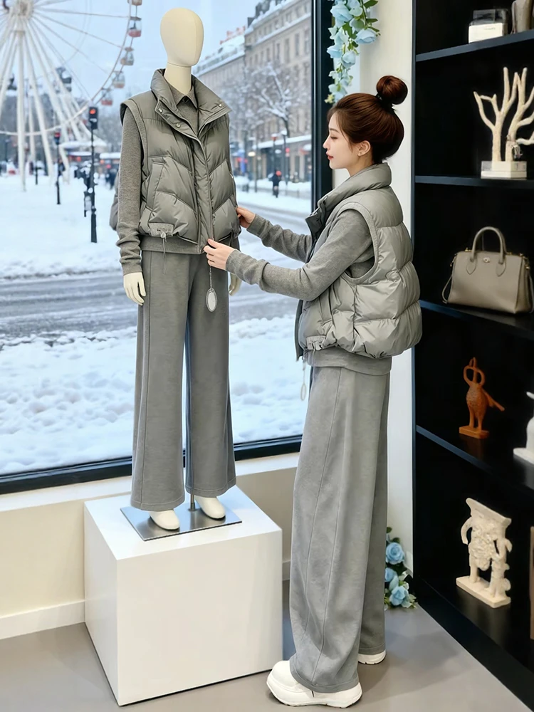 

Женский комплект из трех предметов: утепленный жилет на флисовой подкладке, брюки с высокой талией и широкими штанинами, футболка. Повседневный спортивный модный зимний наряд.