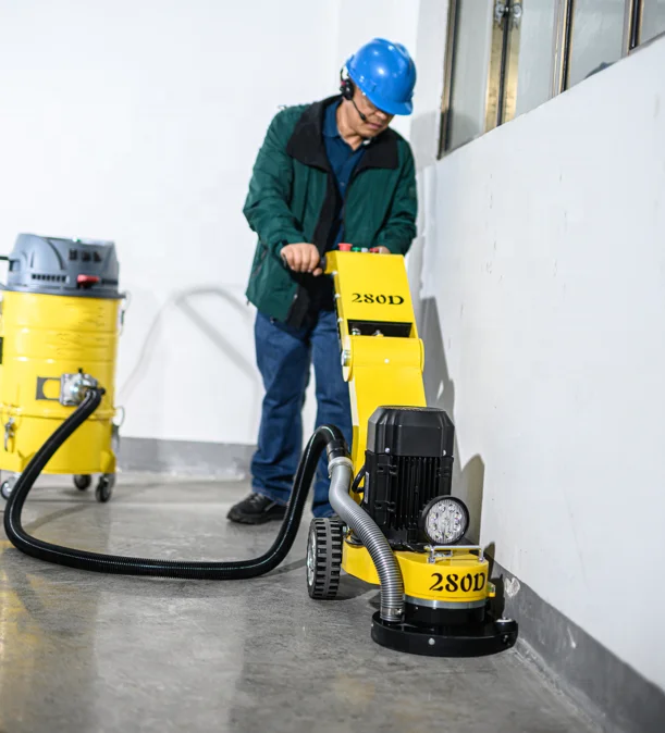 Variable speed walking behind a concrete grinder with a dust collector