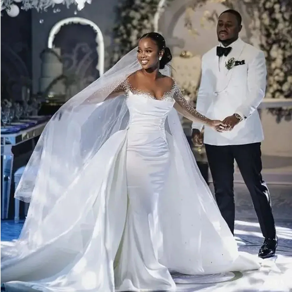 Nuovi abiti da sposa a sirena dell'africa con treno staccabile 2024 collo trasparente manica lunga in raso perline abiti da sposa in cristallo abiti