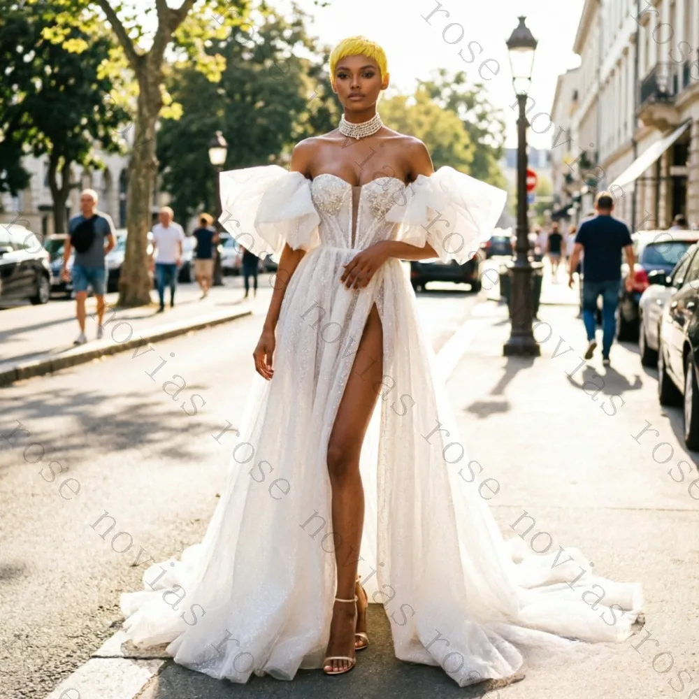 Customized White A-Line Off Shoulder Sparkle Wedding Dress 2026 with Ruffled Sleeves and High Slit for Glamorous Bridal Gown