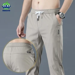 OUSSYU-calça casual reta fina masculina, calça justa, nova marca, primavera, verão, moda masculina, corrida cáqui elástica, 28-38
