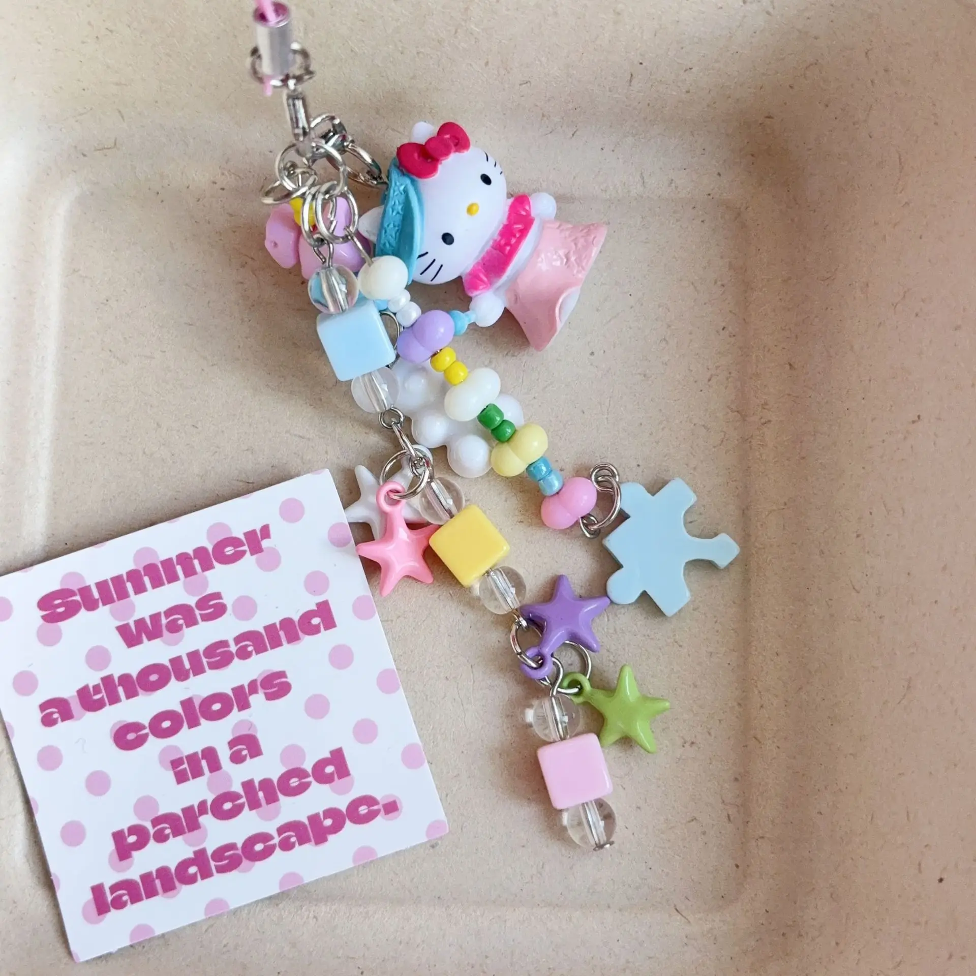 ซานริโอ เฮลโล คิตตี้ ลิตเติ้ล ดอลฟิน หนังสีดำ สายคล้องโทรศัพท์แบบทำมือประดับลูกปัด สายคล้องกระเป๋า สายคล้องกล้อง ของขวัญวันเกิดสำหรับเด็กผู้หญิง