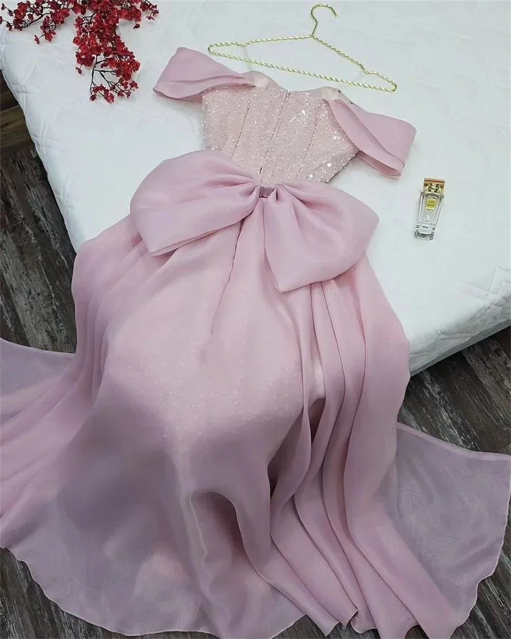 Yipeisha elegant off shoulder pink ball gown with a bow the back and sequins on the body, uniquely designed with dazzling colors