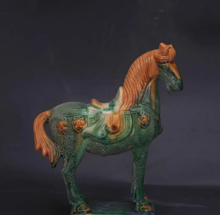 Antique collection and decoration: Tricolor-glazed pottery statue of a horse with green overglaze from the Tang Dynasty