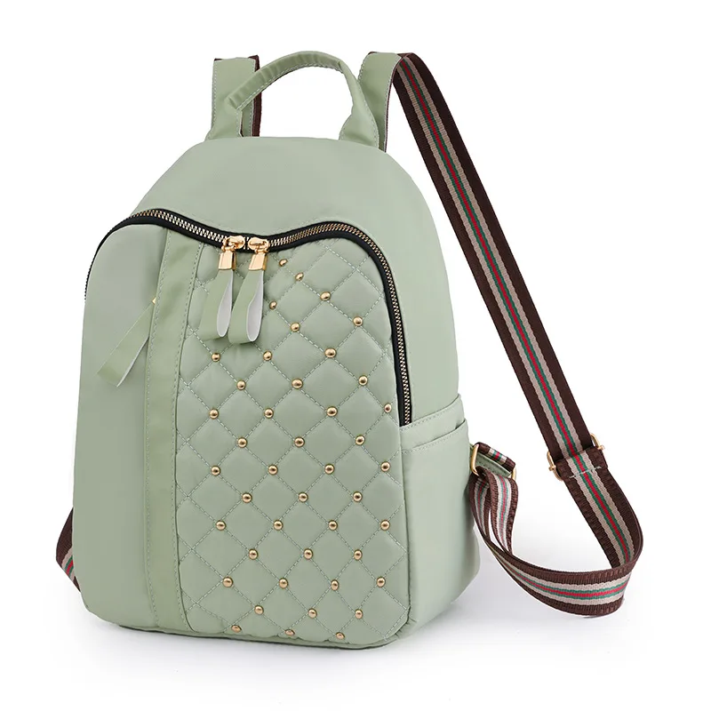 Europe and The United States New Schoolbag New Casual Oxford Cloth Backpack Simple Trend Light Rivet Embroidered Backpack.