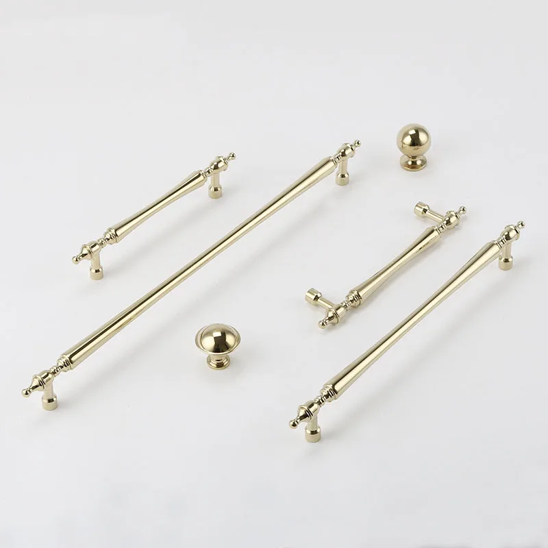 Gold bar handles with two matching round furniture knobs