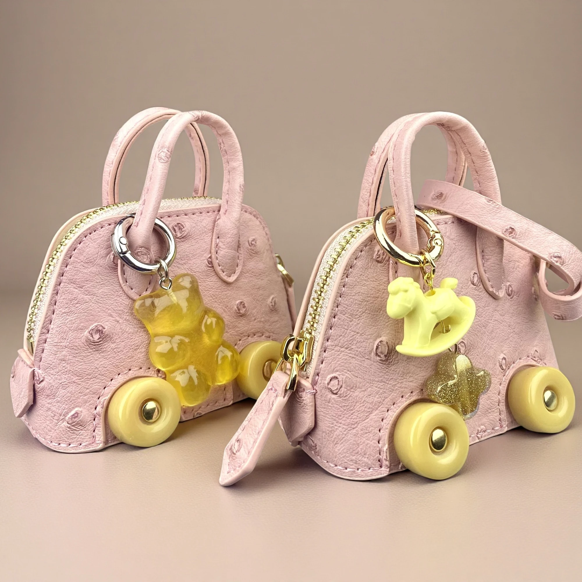 Misty Pink Ostrich-Embossed Mini Wheel Bag Set with Coin Purse And Wireless Earbud Case - Jelly Bear Rocking Horse Jewelry Pouch