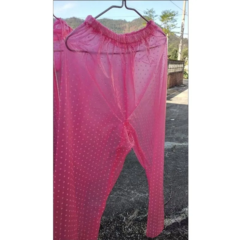 Pantaloni impermeabili in PVC trasparente con pois rosa trasparente. Allentano facilmente la caduta impermeabile
