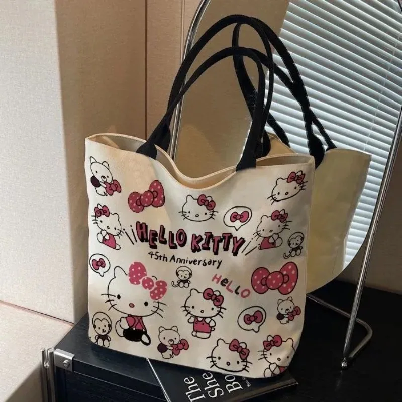 

Kawaii Hello Kitty Canvas Shoulder Bag 2025 New Female Commuter Cartoon Handbag Cartoon Anime Printed Accessory Tote Bag