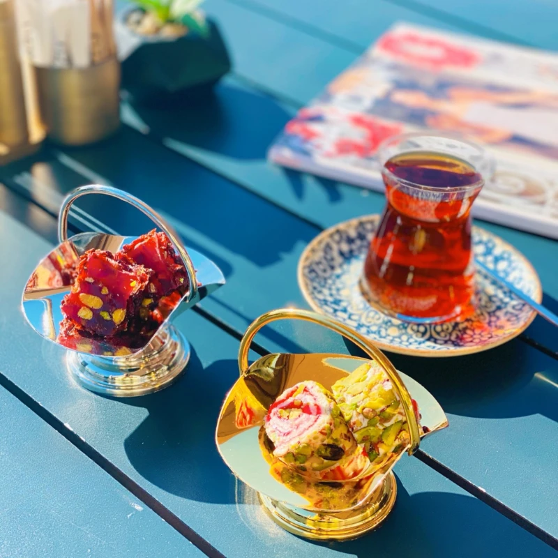 Handmade snacks, sugar cubes, fudge baskets, shelves and red teacups.