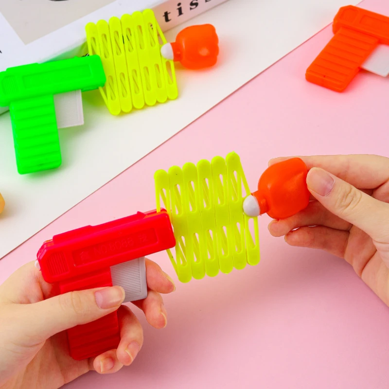 Children's April Fool's Day Prank Novelty Funny Toy Retractable Fist Shooting Skill Gun Decompression Retractable Classic Toy